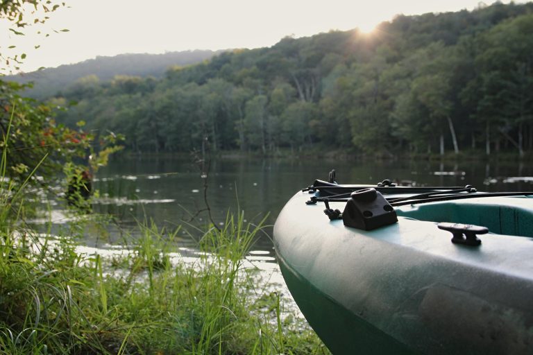 A tranquil kayak scene by the lakeside in Catskill, NY during a summer evening.